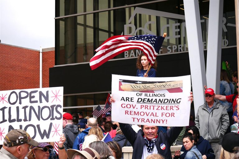 Protesters outside the Bank of Springfield Center in the capital's downtown call for Illinois to reopen sooner than the timeline provided in Gov. JB Pritzker's Restore Illinois plan. Members of the state House met inside the arena for the first of a three-day special session Wednesday. (Capitol News Illinois photo by Ben Orner)