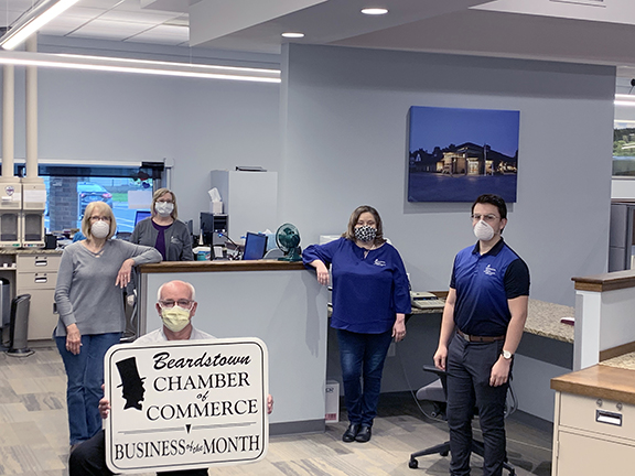 Taking safety precautions at First National Bank, which was named Business of the Month, are Steve Dyche, Ruth Fischer, Janie Ward, Karen Gutman, and Luis Riofrio.