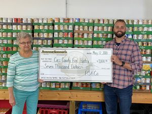 That’s a lot of groceries —Pictured are Joanne Anderson, representing the Cass County Food Pantry, and Chris Barrett, Cass County Division President for Petefish, Skiles & Co. Bank, with a check for the food pantry. (Photo provided.)
