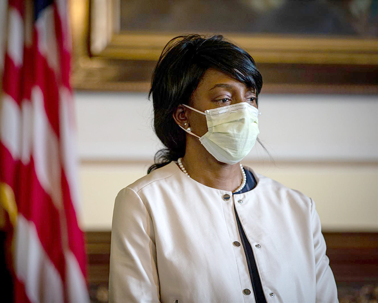 Dr.Ngozi Ezike, director of the Illinois Department of Public Health, listens to Gov. JB Pritzker answer reporters' questions during a COVID-19 briefing Friday in his office at the Capitol in Springfield. (Pool photo by Justin L. Fowler/The State-Journal Register)
