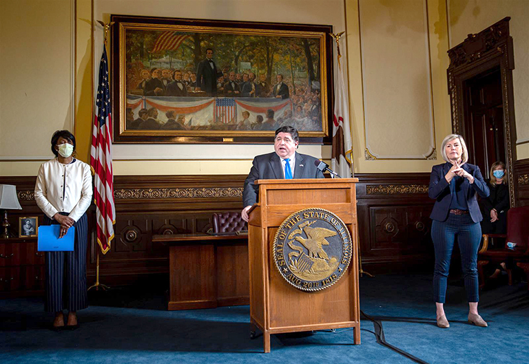 Gov. JB Pritzker and Dr. Ngozi Ezike, director of the Illinois Department of Public Health, brief the media Friday on the state's COVID-19 pandemic during a news conference in the governor's office at the Capitol in Springfield. (Pool photo by Justin L. Fowler/State Journal-Register)