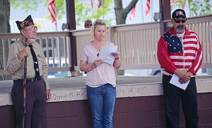 Sharing a verse — Flanked by Dale Lovekamp, (left) and Adrian DeLoche (right) Amanda Thurman shares a poem written about the sacrifices of war written by a Chandlerville resident. The poem was part of an impromptu Memorial Day observance held in Beardstown Monday.