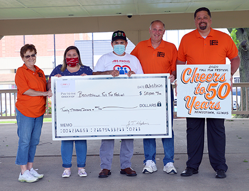 A generous gift — Members of the Beardstown Fall Fun Festival Committee received a $20,000 donation from JBS Beardstown and UFCW Local 431 to help fund the festival’s 50th Anniversary celebration. Fall Festival Treasurer Brenda Fishel receives the check from Chelsee Cornelius (JBS) and Sergio Ruiz (Local 431.) Also on hand for the presentation were Tom Schlueter and Scott Lummis. The logo for this year’s festival being held by Lummis was donated by Flowers Signworx. (Photo by Brian DeLoche.)
