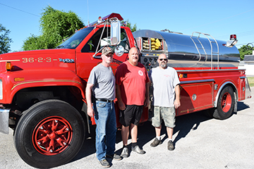 The Chandlerville Fire Department acquired a 1991 GMC tanker/pump truck June 25, purchasing the truck from the Shawnee on Delaware, PA fire department. The truck has 12,000 miles and has a 2,000 gallon water capacity. Pictured, left to right, are Assistant Fire Chief Mike Ryan, Chandlerville Mayor Tim Richard and Fire Chief Chuck Force.