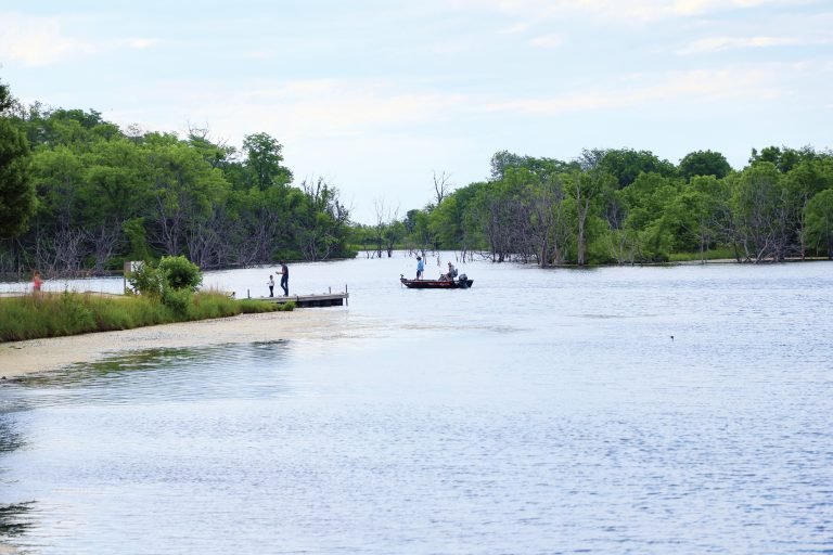 Gone fishin’ —Fishing opportunities abound at the Jim Edgar Panther Creek State Fish and Wildlife Area.  Here, anglers try their luck on shore and in a boat at Gridley Lake. (photo by Brian DeLoche.)