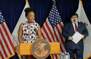 llinois Department of Public Health Director Dr. Ngozi Ezike speaks at a COVID-19 news conference in Chicago Wednesday as Gov. JB Pritzker looks on. (Credit: Blueroomstream.com)