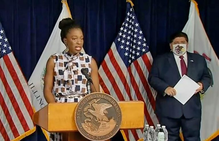 llinois Department of Public Health Director Dr. Ngozi Ezike speaks at a COVID-19 news conference in Chicago Wednesday as Gov. JB Pritzker looks on. (Credit: Blueroomstream.com)
