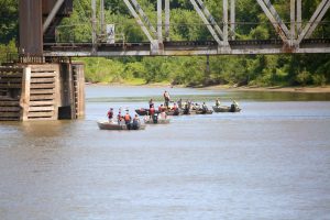 Focused attention — Volunteers from throughout the Illinois River Valley, as well as some from Rock Island and Wisconsin, concentrate their efforts near a support pier of the Burlington-Northern Santa Fe Railroad bridge in the attempt to locate the bodies of Briston and Jorden Dunmire last Friday morning. Photo by Brian DeLoche