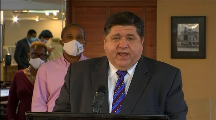 Gov. JB Pritzker speaks at a news conference in Chicago Tuesday. He announced the next round of Business Interruption Grants and warned of future state budget cuts without further federal government intervention. (Credit: Blueroomstream.com)