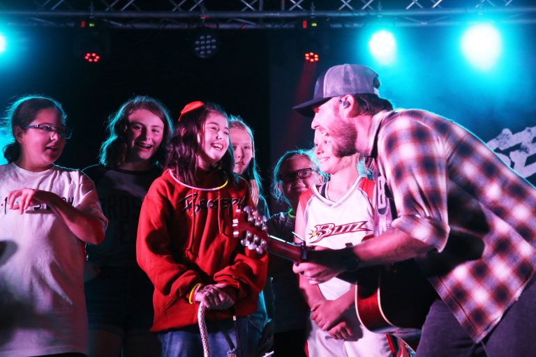 This song’s for you ­­— Brock Jones, lead singer for the band “Broseph” turns his attention to Alayna Capps during a concert Saturday night highlighting a weekend of fundraising activities to help off set medical and travel expenses connected to her fight with a brain tumor. (Photo by Brian DeLoche.)