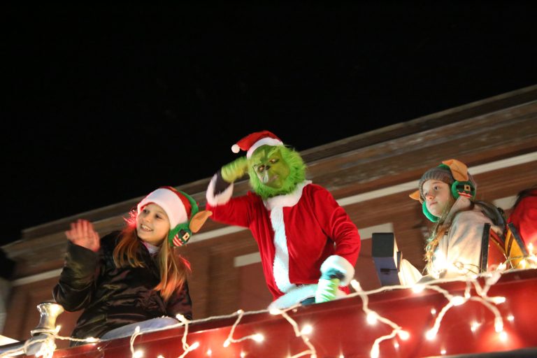 Among the best — The Grinch riding aboard an old firetruck owned and operated by TJ Pratt took top honors for the best non-float entry in Saturday night’s 12th annual Nighttime Christmas Parade sponsored by the Beardstown Chamber of Commerce and Beardstown C.O.N.N.E.C.T. Joining the Grinch on the firetruck were Stella Swingle and  Cami Coats. (Photo by Brian DeLoche.)