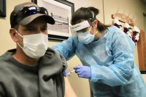 Small shot, big protection — Brandon Hager, a Beardstown firefighter and part-time EMT with the ambulance department, was among the first Beardstown residents to receive the COVID-19 vaccine Monday afternoon from Cass County Health Department Nurse Brandi Hymes.(Photo by Brian DeLoche)