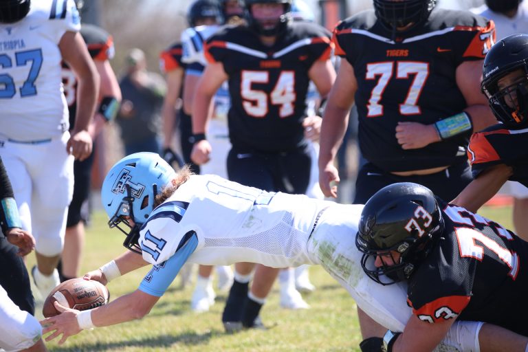 Stretching for the score — Triopia’s Conner Musch fights through a tackle and extends the ball over the goal line for a score in Saturday’s one-sided 51-14 victory over the Beardstown Tigers at Nick Carter Field.    (Photo by Brian DeLoche.)