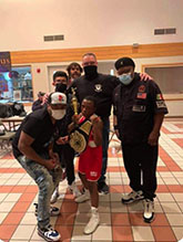Cass County Boxing Club member  Mikyel “Popcorn” McGowan of Beardstown brought home the hardware from his fight with Eli Stinehart of Driscolls Boxing Academy, Centralia. The event was held April 9th at the Polish Heritage Center in St. Louis, MO. He is surrounded by family members and Coaches Randy Schoonover and Reggie Williams on the right.