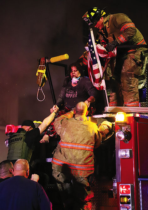 One resident of the apartments had to have help escaping the rapidly spreading flames.Firefighters were able to get her out of an upper floor window. She was treated for non-life threatening injuries. Fire photos by Brian DeLoche.