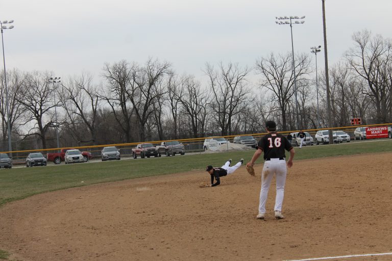 Tiger shortstop William Davidsmeier makes a diving attempt at a ground ball in the hole in a victory over Rushville at home.    Photo by Jason Brockschmidt
