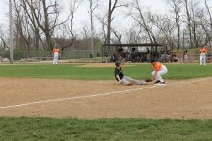 Freshman third bagger Ethan Heller applies the tag, cutting down a Panther runner at third base in a Tiger victory.   Photo by Jason Brockschmidt