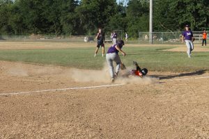 Beardstown's Trey Riddell is out in a cloud of dust trying to stretch a double into a triple at Ed Lewis Field in Junior League All Star action.