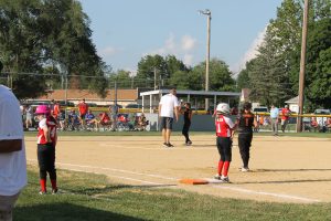 Coach Adam Swingle gives some words of encouragement to his pitcher and daughter Stella Swingle during District 17 Girls 9/10 year old softball action.