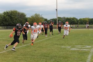 JV Quarterback Parker McCoy turns upfield for good yardage in football action against Greenfield/Northwestern.