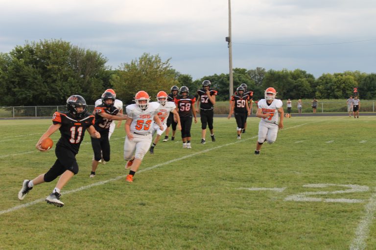 JV Quarterback Parker McCoy turns upfield for good yardage in football action against Greenfield/Northwestern.