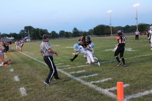 Micah Wink battles for extra yardage through two Triopia tacklers as Ryan McClenning looks on in the Tigers 54-14 win over the Trojans.