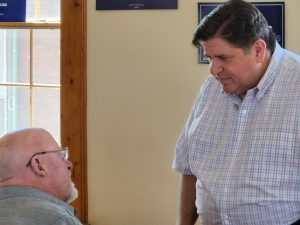 Gov. Pritzker with Cass County residents.