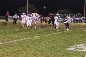 In an all too familiar sight, Tiger running back Christy Domitien is caught in the backfield with four more Hornet tacklers running free in pursuit in the homecoming game loss to Brown County. Photo by Jason Brockschmidt