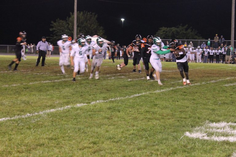 In an all too familiar sight, Tiger running back Christy Domitien is caught in the backfield with four more Hornet tacklers running free in pursuit in the homecoming game loss to Brown County. Photo by Jason Brockschmidt