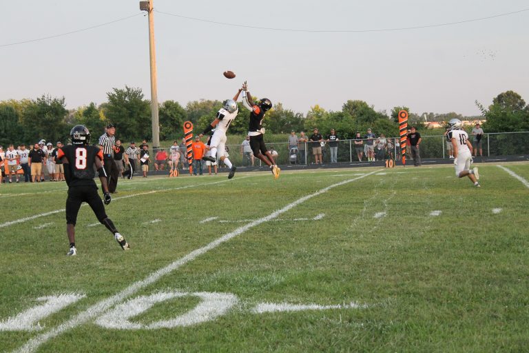 Lucas Domitien of the Tigers and the West Central defender extend as high as possible in pursuit of the pass. Photo by Jason Brockschmidt