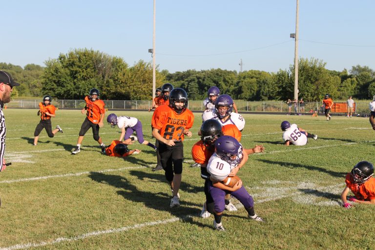 Josh Camas makes a perfect tackle as Christian Milan (83) comes in to finish off the ball carrier in Junior High football action against Rushville.