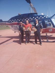 Air Evac representatives, Morgan Vetter, left, and Adam Crum, right, accept a gift basket presented by Buchheit of Jacksonville Manager Kurt Beckmann, center.
