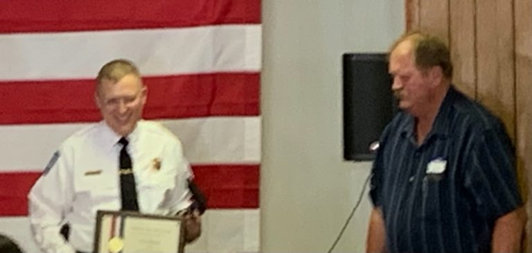 Chapin  Police Chief Steve Helmich receives the Purple Heart Award for being Injured in the line of Duty in March of this Year from Village President Rex Brockhouse