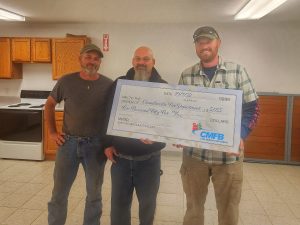 CMFB board members David Wessel, left,  and Jeff Carl, rights presents $5,055 to Chief Chuck Force, middle, Chandlerville Fire Department.