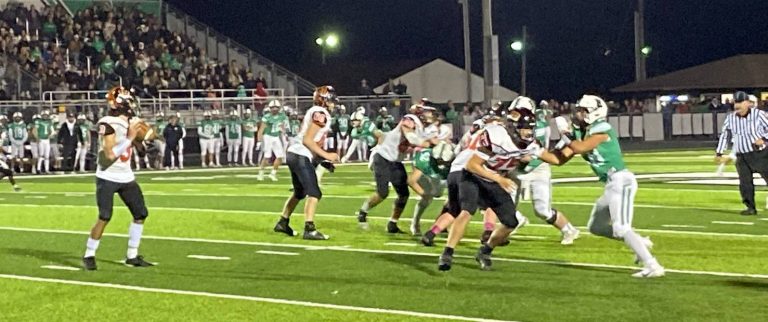 Quarterback Owen Quigley stands in the pocket on the turf as the Tiger line provides great protection in Beardstown’s playoff loss at Eureka. Photo by Brockschmidt