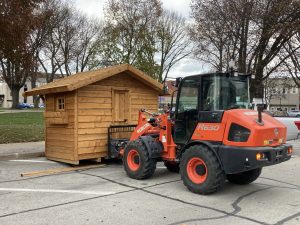 Volunteers place one of the new chalets in Art Zeeck Park