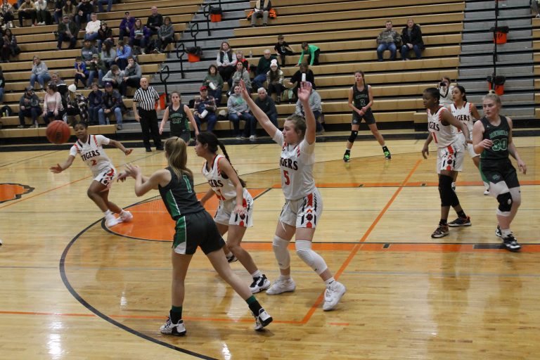 Kylynn Maltby (#5) and Ari Garcia of Beardstown force a bad pass and Chrinovie Kondua (#2) moves for the steal in Lady Tiger Classic opening day play.