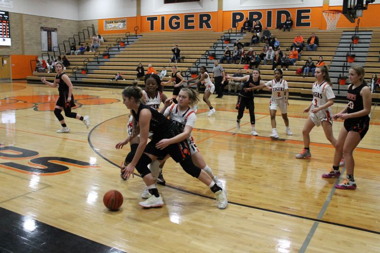 Bertille Kayembe (left) and Kylynn Maltby (right) apply intense pressure in home girls varsity basketball action.