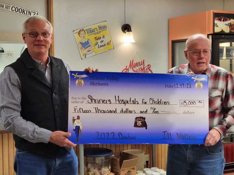 Jack Bell (right) of Illinois Valley Shrine Club  presented  a check  for $15,000 to  Stan Harris, (left)  Potentate of Ansar Shine, at the club’s annual Christmas party on December 17.The Shrine Club hosts fundraisers thoughout the year to raise money to help support the children’s hospitals. Photo by Jaime Chapman