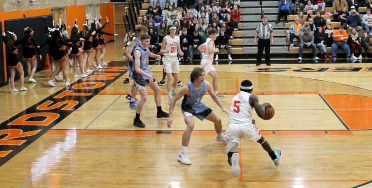 Senior Lucas Domitien drives to the hoop for the Tigers versus North Mac in varsity basketball action.