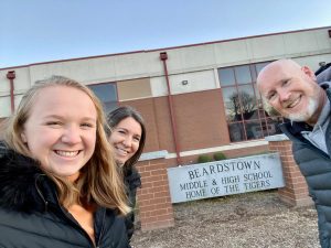 Superintendent Smith stands in front of Beardstown Middle and High School along with his daughter, Ashton (left), and his wife Shannon (right).
