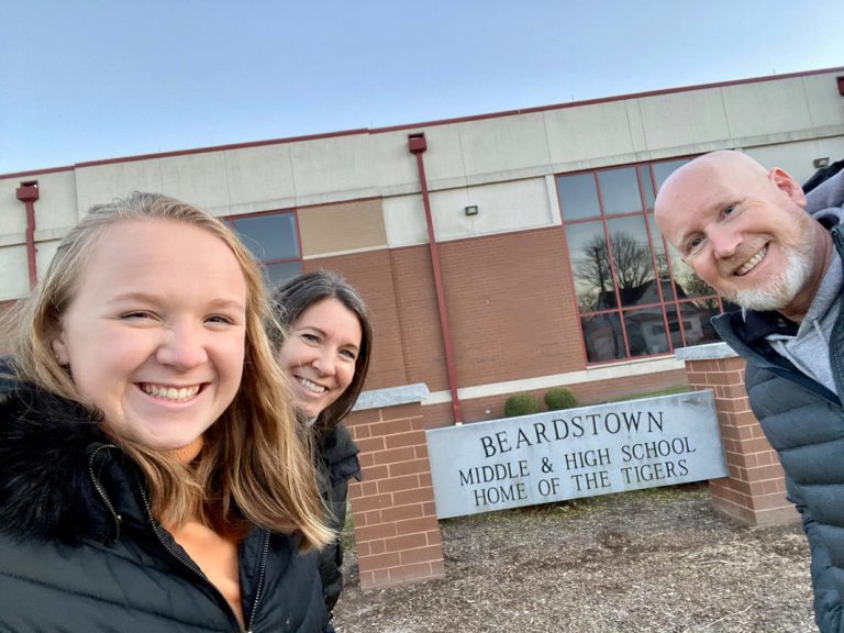Superintendent Smith stands in front of Beardstown Middle and High School along with his daughter, Ashton (left), and his wife Shannon (right).