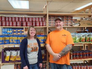 Sarah and Joe Engelbrecht stand before stocked shelves at the new Beardstown Food Pantry.