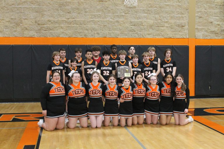 The Beardstown 8th grade boys basketball team and cheerleaders are pictured with the Regional Championship plaque following the Tigers win over Quincy St. Peter.