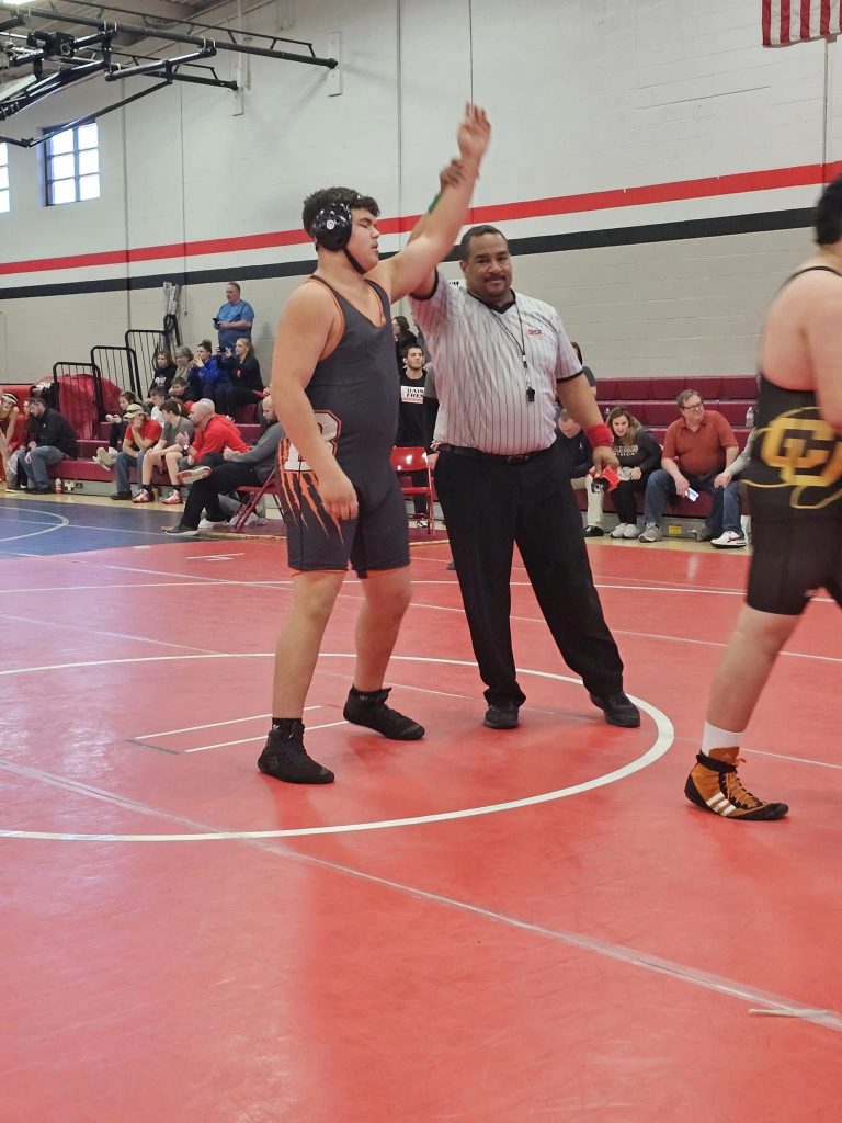 The referee raises the hand of Garrett Dailey of Beardstown following his state trip clinching victory in Fresh/Soph Sectional wrestling action.