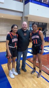 Beardstown Seniors Chrinovie Kondua, left, and Bertille Kayembe, right, along with Coach Jimmy Maltby, center, at the Westown Ford-Lincoln Senior Girls All-Star basketball game held at Illinois College.