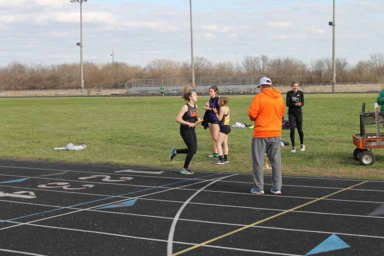 Beardstown’s Georgia Brown crosses the finish line to finish a relay race for the Tigers.
