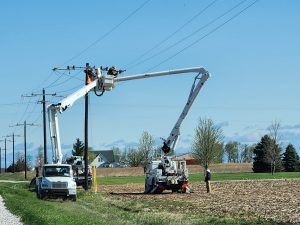 Pictured above, two crews in bucket trucks work to get the lines in order.   Photo by Jaime Chapman