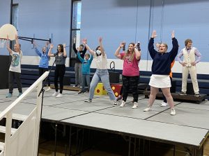 Pictured above are members of the cast practicing a number.  Photo submitted