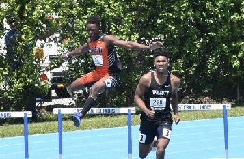 Jean Luc Aplogan of BHS clears a hurdle during the 300 meter competition at the IHSA Track and Field Championships.